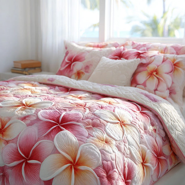Blushing Bloom quilted 3-piece bedding set on a made bed with two matching pillow shams
