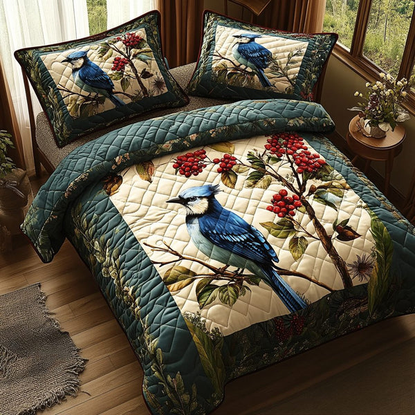 Bold Blue Wings quilted 3-piece bedding set on a made bed with two matching pillow shams