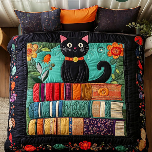 Bookish Black Cat quilted 3-piece bedding set on a made bed with two matching pillow shams