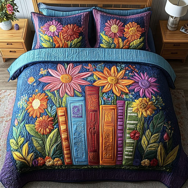 Bookish Blooms quilted 3-piece bedding set on a made bed with two matching pillow shams