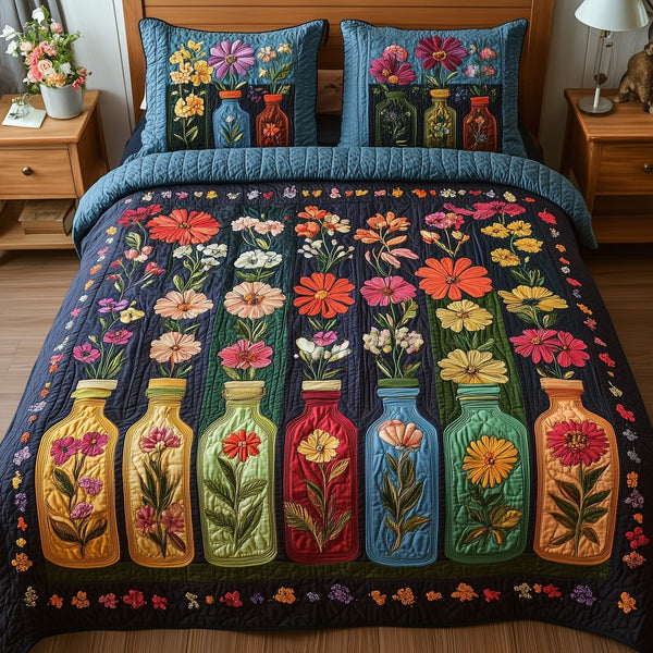 Bottle Of Blossom quilted 3-piece bedding set on a made bed with two matching pillow shams