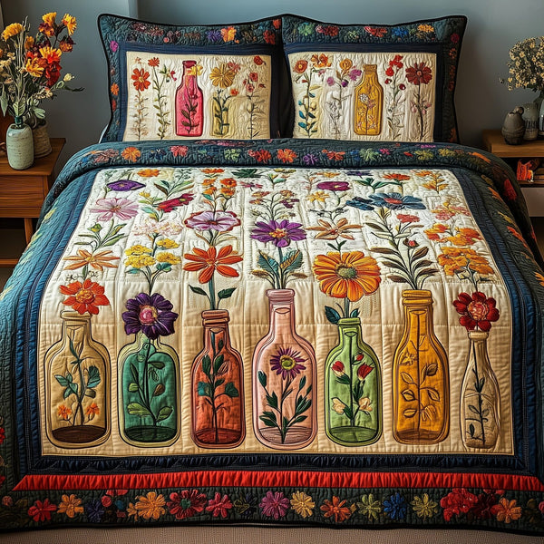 Bottle Of Blossom quilted 3-piece bedding set on a made bed with two matching pillow shams