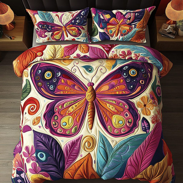 Butterfly Bloom quilted 3-piece bedding set on a made bed with two matching pillow shams
