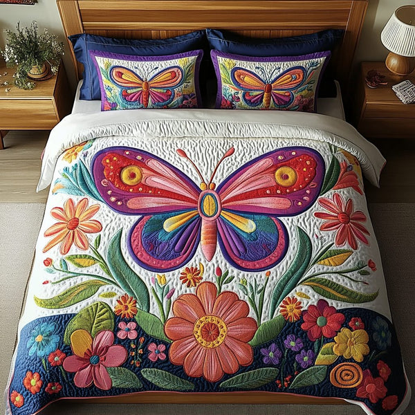 Butterfly Dreams quilted 3-piece bedding set on a made bed with two matching pillow shams