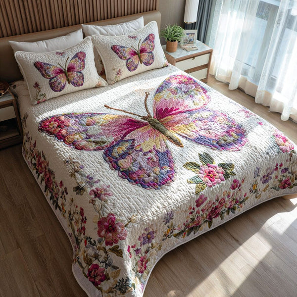 Butterfly Meadow quilted 3-piece bedding set on a made bed with two matching pillow shams