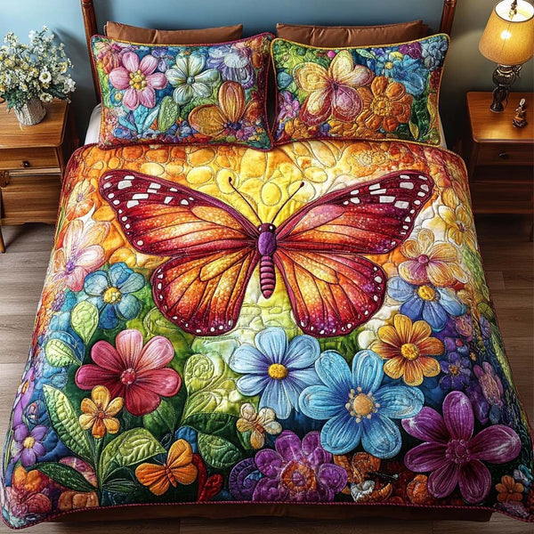 Butterfly Whispers quilted 3-piece bedding set on a made bed with two matching pillow shams