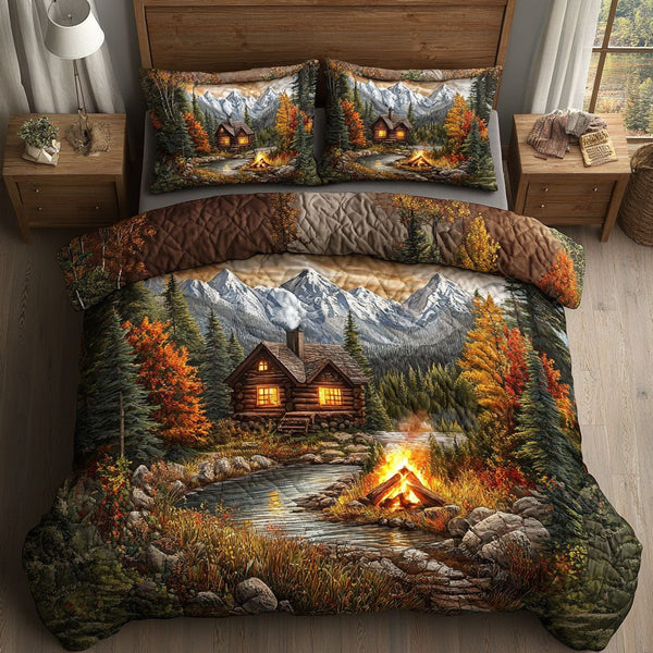 Cabin Campfire Mountains quilted 3-piece bedding set on a made bed with two matching pillow shams