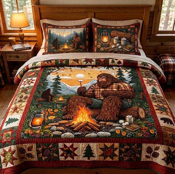 Campfire Sasquatch quilted 3-piece bedding set on a made bed with two matching pillow shams