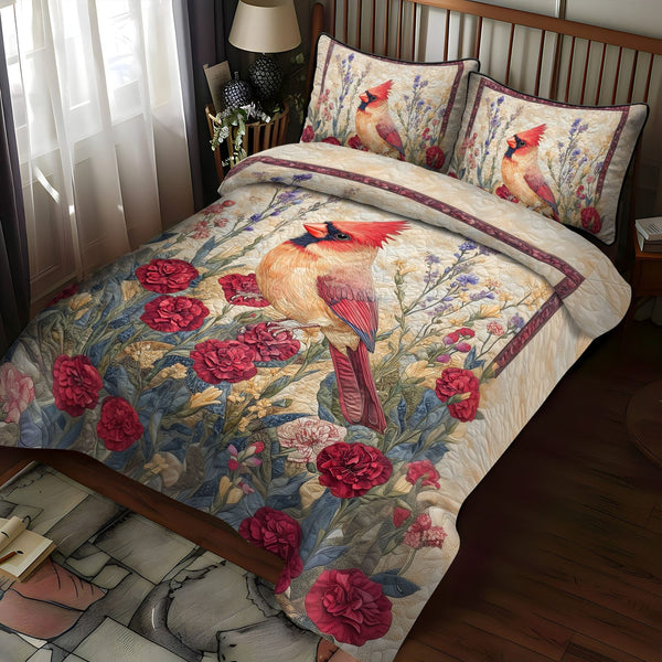 Cardinal and Carnations quilted 3-piece bedding set on a made bed with two matching pillow shams