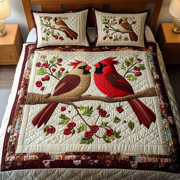 Cardinal Hearts quilted 3-piece bedding set on a made bed with two matching pillow shams