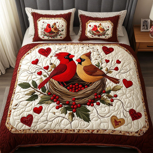 Cardinal Love Circle quilted 3-piece bedding set on a made bed with two matching pillow shams