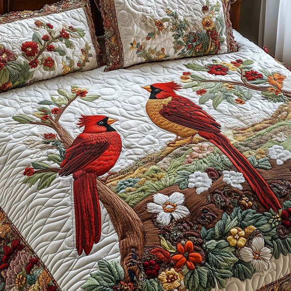 Cardinal Love Dance quilted 3-piece bedding set on a made bed with two matching pillow shams