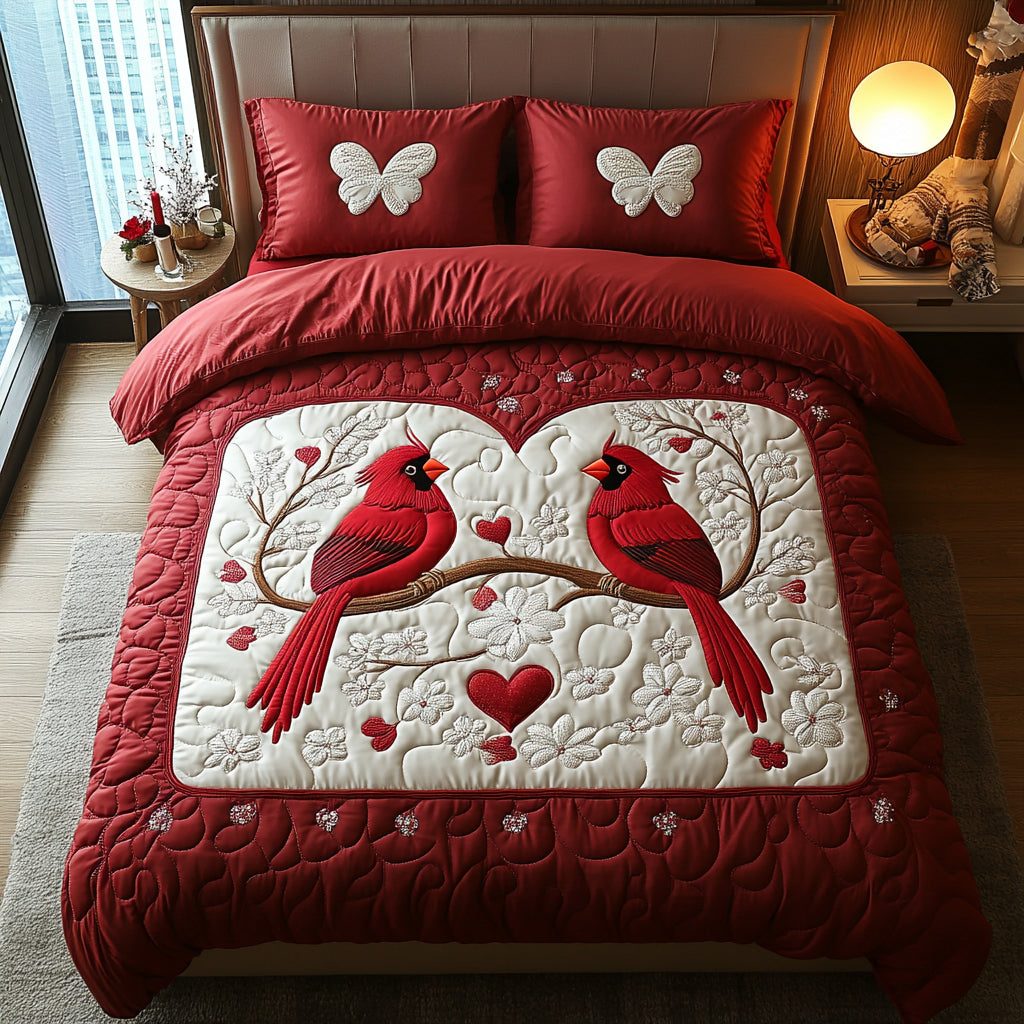 Cardinal Romance quilted 3-piece bedding set on a made bed with two matching pillow shams