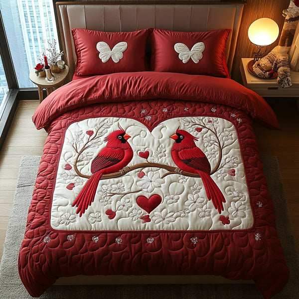 Cardinal Romance quilted 3-piece bedding set on a made bed with two matching pillow shams