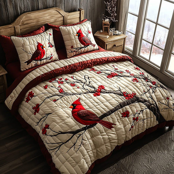 Cardinal Whispers quilted 3-piece bedding set on a made bed with two matching pillow shams
