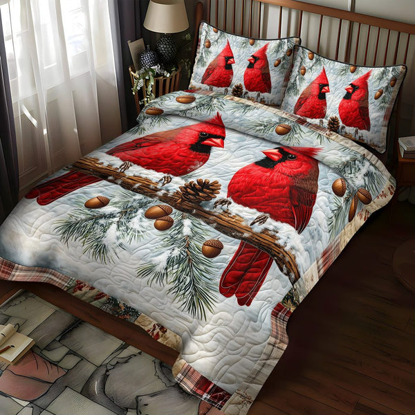 Cardinals in Snow quilted 3-piece bedding set on a made bed with two matching pillow shams