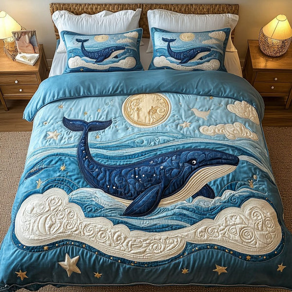 Celestial Blue Whale quilted 3-piece bedding set on a made bed in a light coastal bedroom