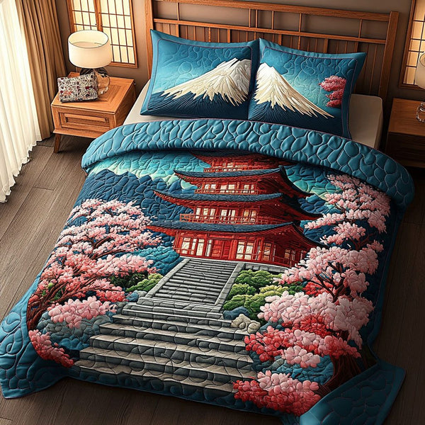 Cherry Blossom Path quilted 3-piece bedding set on a made bed with two matching pillow shams