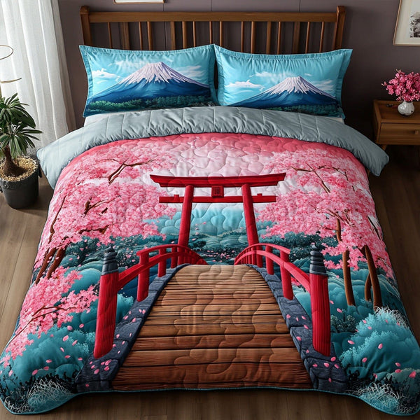 Cherry Blossom Vista quilted 3-piece bedding set on a made bed with two matching pillow shams
