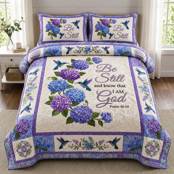Christian Hydrangea Garden quilted 3-piece bedding set on a made bed in a softly lit bedroom
