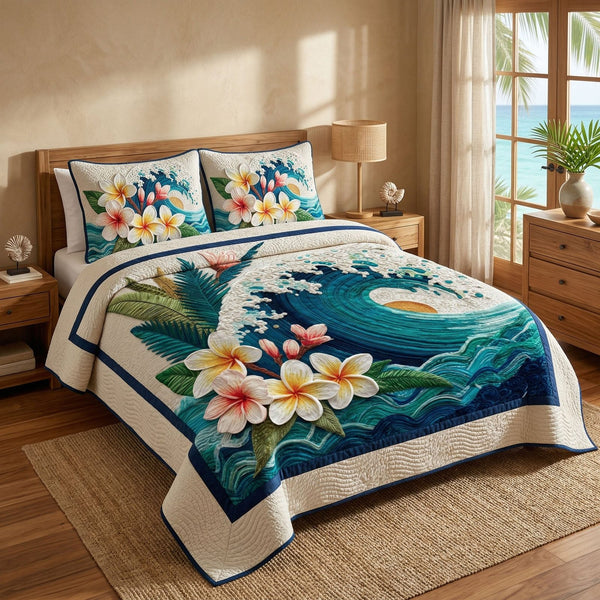 Coastal Plumeria quilted 3-piece bedding set on a made bed in a light coastal bedroom