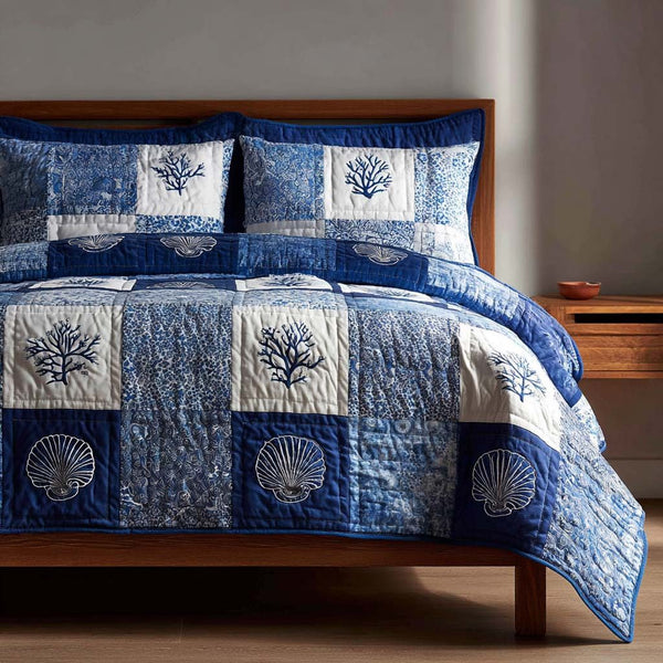 Coastal Shells quilted 3-piece bedding set on a made bed in a light coastal bedroom