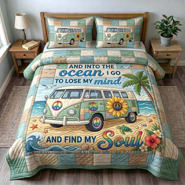 Coastal Wanderer quilted 3-piece bedding set on a made bed in a light coastal bedroom