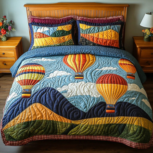 Colorful Ascent quilted 3-piece bedding set on a made bed with two matching pillow shams