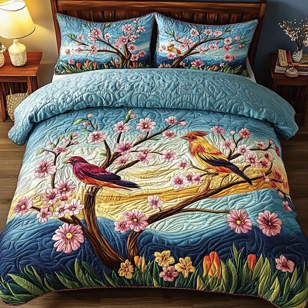 Colorful Birds quilted 3-piece bedding set on a made bed with two matching pillow shams