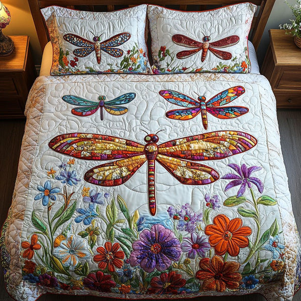Colorful Dragonfly quilted 3-piece bedding set on a made bed with two matching pillow shams