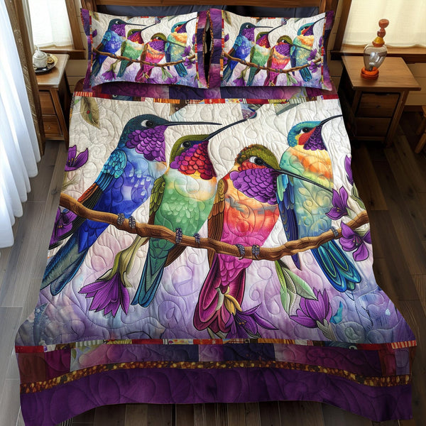 Colorful Hummingbirds quilted 3-piece bedding set on a made bed with two matching pillow shams
