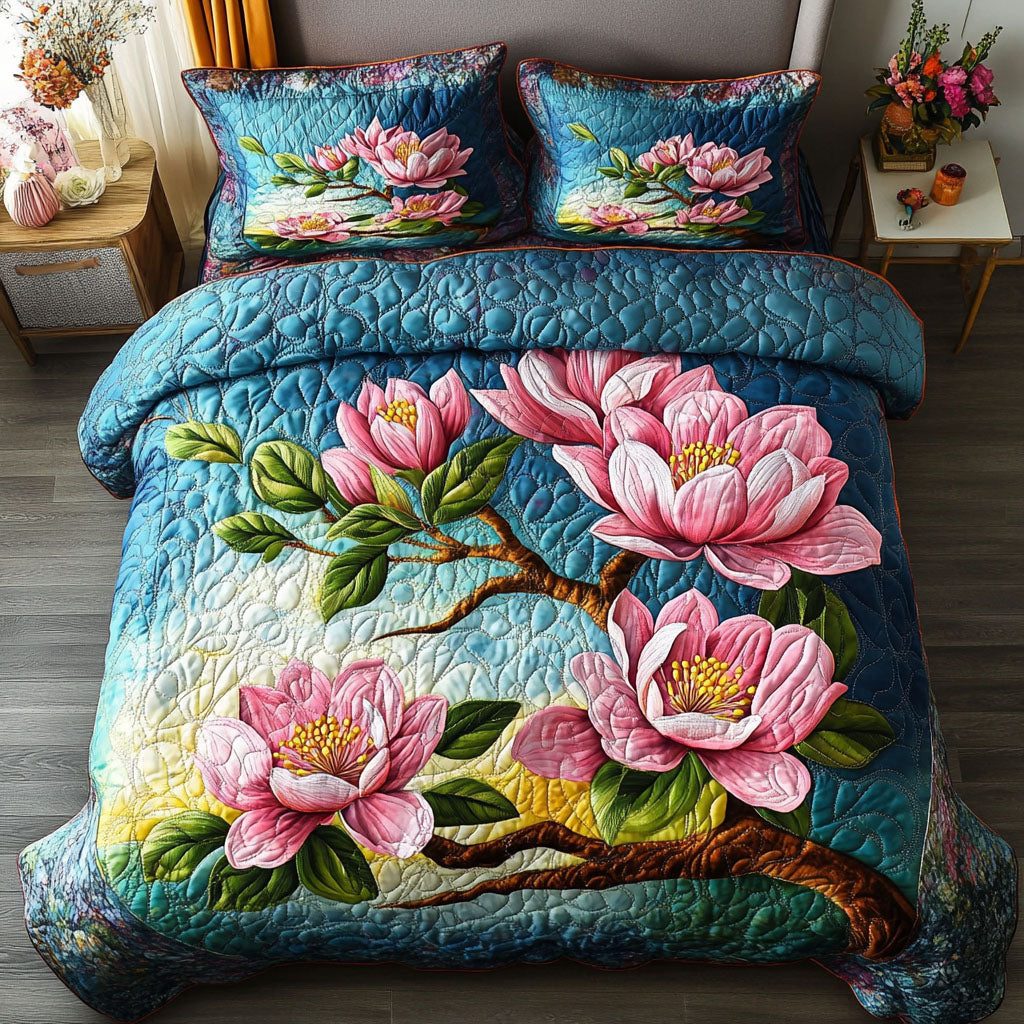 Colorful Magnolia Garden quilted 3-piece bedding set on a made bed with two matching pillow shams