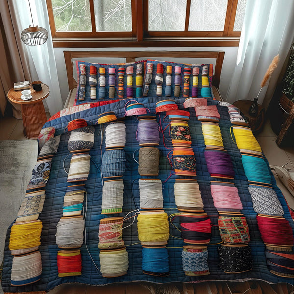 Colorful Spools quilted 3-piece bedding set on a made bed with two matching pillow shams