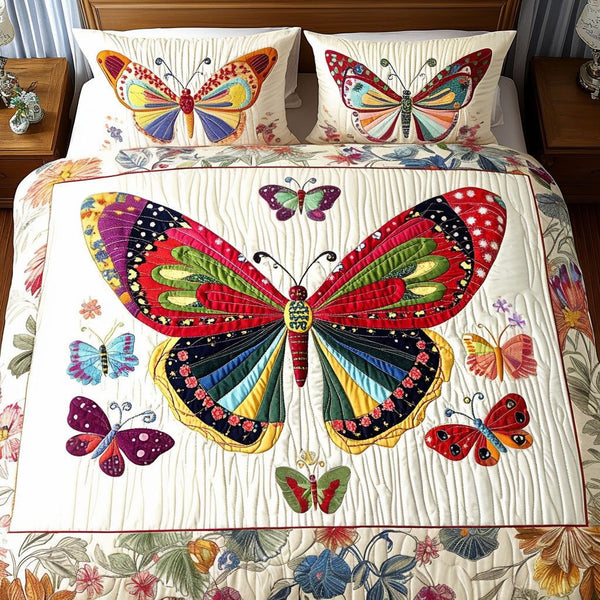Colorful Wings quilted 3-piece bedding set on a made bed with two matching pillow shams