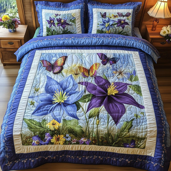 Columbine Charm quilted 3-piece bedding set on a made bed with two matching pillow shams