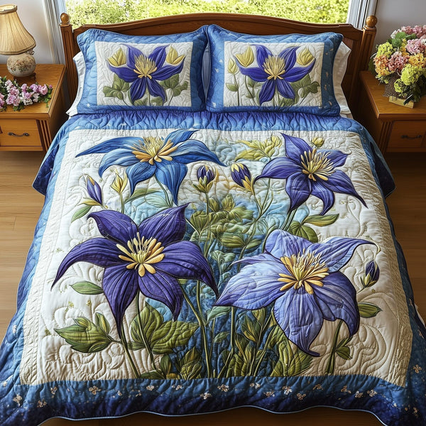 Columbine Charm quilted 3-piece bedding set on a made bed with two matching pillow shams
