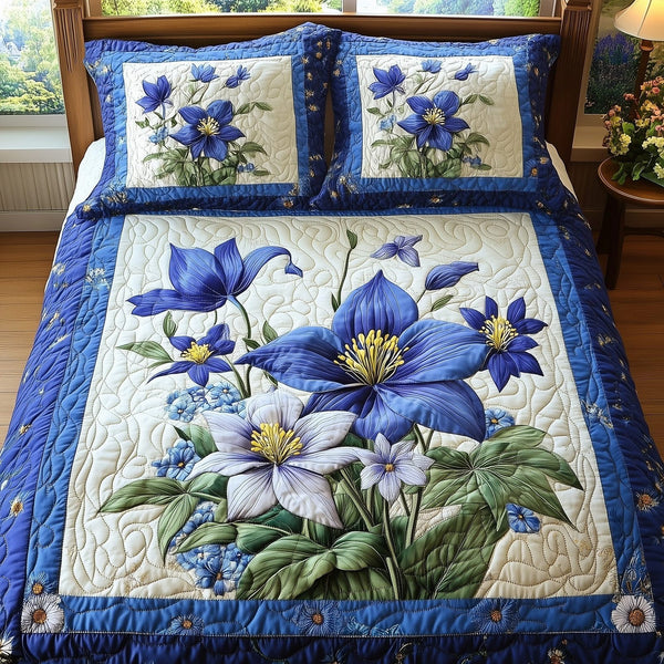Columbine Charm quilted 3-piece bedding set on a made bed with two matching pillow shams