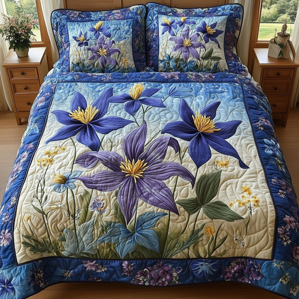 Columbine Charm quilted 3-piece bedding set on a made bed with two matching pillow shams