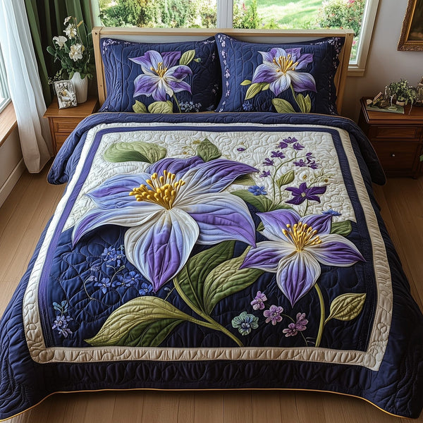 Columbine Charm quilted 3-piece bedding set on a made bed with two matching pillow shams
