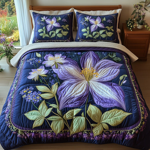 Columbine Charm quilted 3-piece bedding set on a made bed with two matching pillow shams