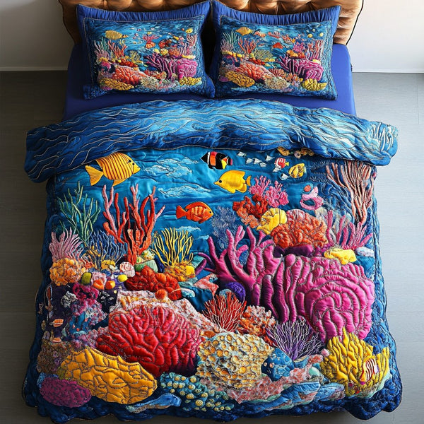 Coral Reef Bliss quilted 3-piece bedding set on a made bed in a light coastal bedroom
