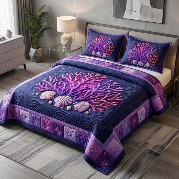 Coral Reef quilted 3-piece bedding set on a made bed in a light coastal bedroom