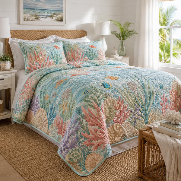 Coral Reef quilted 3-piece bedding set on a made bed in a light coastal bedroom