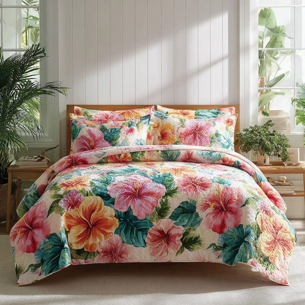 Coral Reef quilted 3-piece bedding set on a made bed in a light coastal bedroom