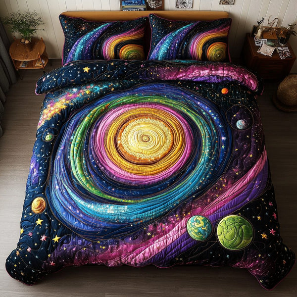 Cosmic Glow quilted 3-piece bedding set on a made bed with two matching pillow shams