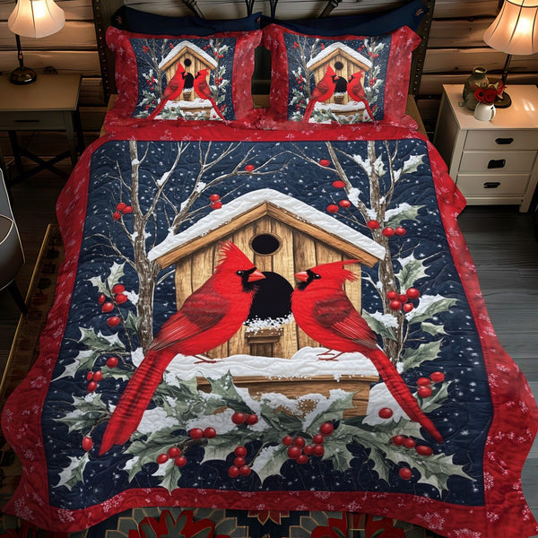 Cozy Cabin Cardinals quilted 3-piece bedding set on a made bed with two matching pillow shams