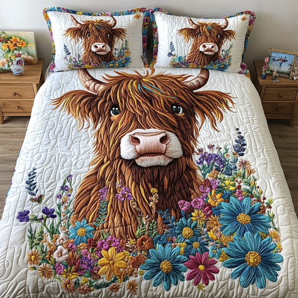 Cozy Cow quilted 3-piece bedding set on a made bed with two matching pillow shams