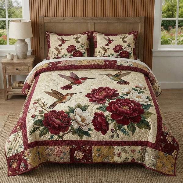 Crimson Bloom quilted 3-piece bedding set on a made bed with two matching pillow shams