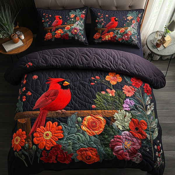 Crimson Cardinal quilted 3-piece bedding set on a made bed with two matching pillow shams