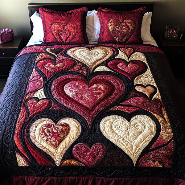 Crimson Hearts quilted 3-piece bedding set on a made bed with two matching pillow shams